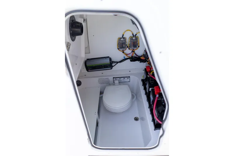 Slide: The Image of Interior view of 2026 Sportsman Heritage 231 Center Console boat's compact bathroom. - 23