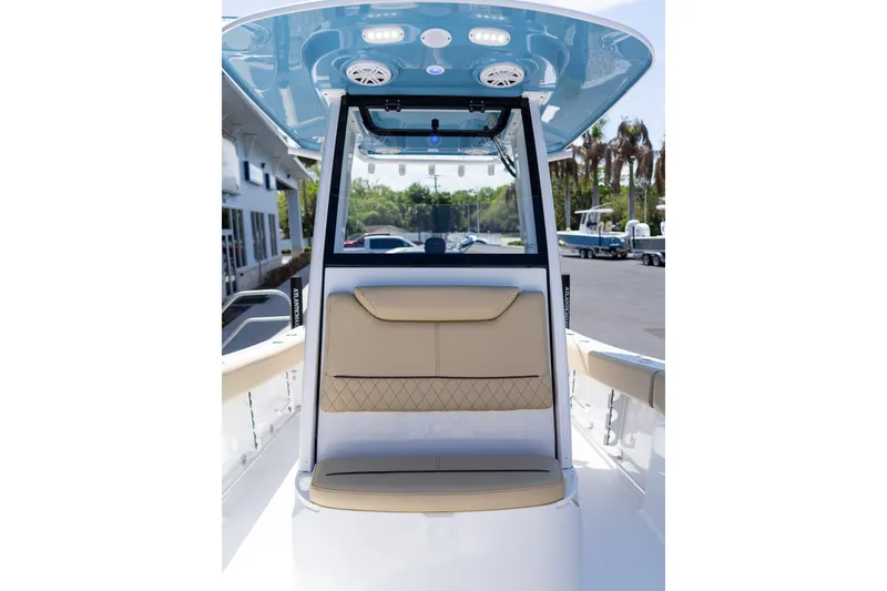 Slide: The Image of 2026 Sportsman Heritage 231 Center Console boat interior with beige seating and blue canopy. - 29