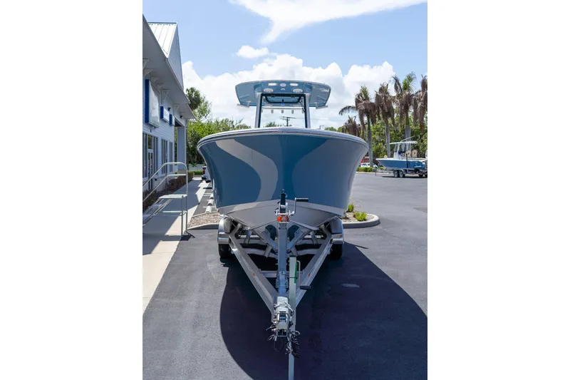 Slide: The Image of 2026 Sportsman Heritage 231 Center Console boat on trailer, parked outdoors. - 3