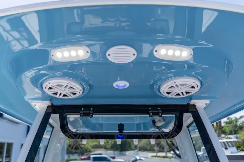 Slide: The Image of 2026 Sportsman Heritage 231 Center Console boat's overhead speakers and lights. - 30