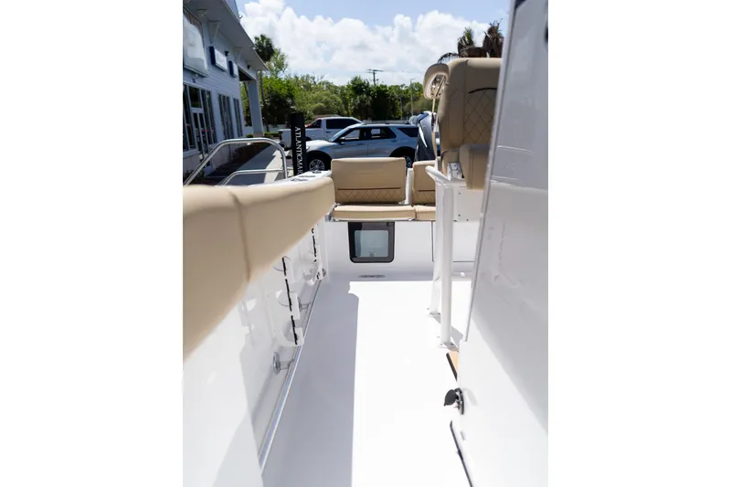 Slide: The Image of 2026 Sportsman Heritage 231 Center Console boat interior with beige seating and sleek design. - 32