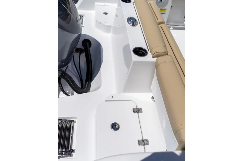 Slide: The Image of 2026 Sportsman Heritage 231 Center Console boat interior with tan seating and storage compartment. - 33