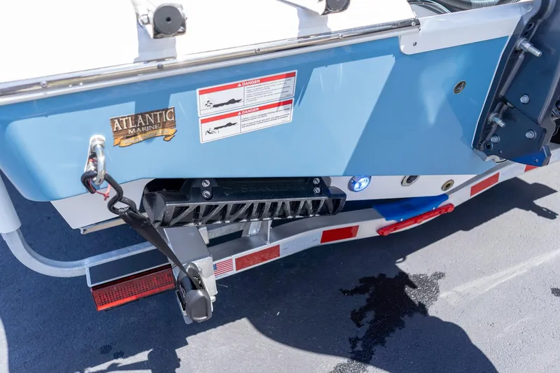 Slide: The Image of 2026 Sportsman Heritage 231 Center Console boat rear view with trailer and safety labels. - 37