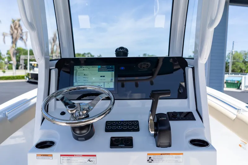 Slide: The Image of Center console of 2026 Sportsman Heritage 231 boat with steering wheel and controls. - 38
