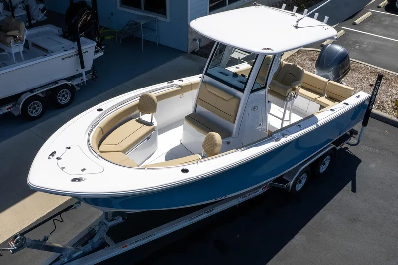 Slide: The Image of 2026 Sportsman Heritage 231 Center Console boat on trailer, featuring sleek design and spacious seating. - 4