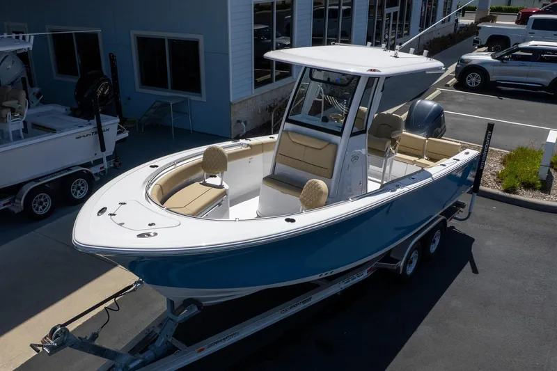 Slide: The Image of 2026 Sportsman Heritage 231 Center Console boat on trailer, parked outside dealership. - 8
