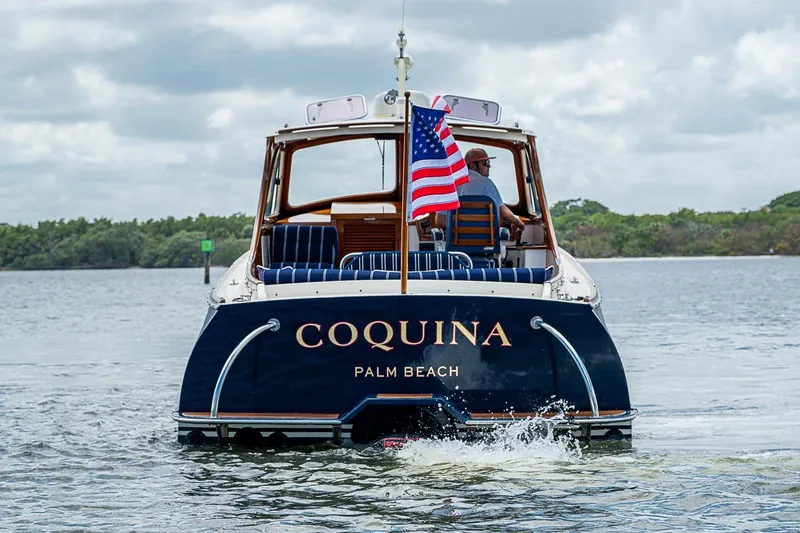 The Image of Hinckley Picnic Boat 36 Classic, 2001, cruising on water with American flag. - 0