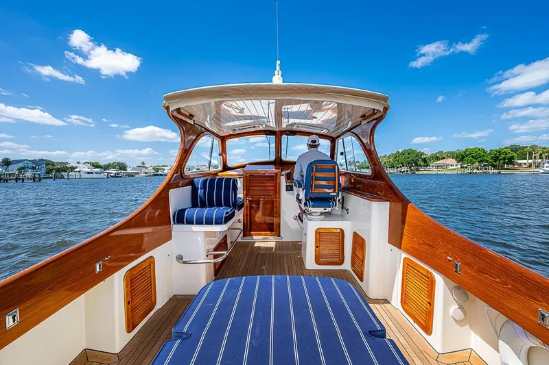 Slide: The Image of 2001 Hinckley Picnic Boat 36 Classic cruising on a sunny day, featuring elegant woodwork and striped seating. - 10