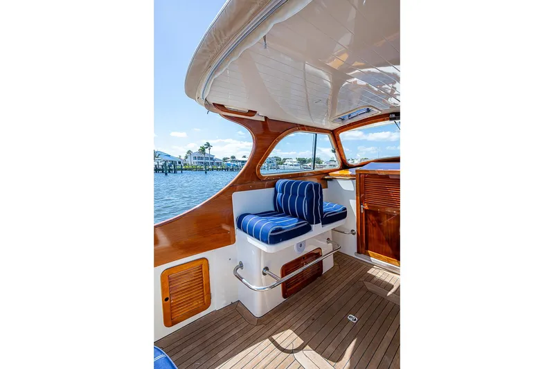 Slide: The Image of Interior of 2001 Hinckley Picnic Boat 36 Classic with striped seating and wooden accents. - 12