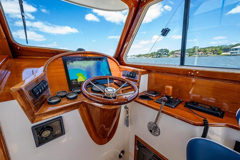 Slide: The Image of Helm of 2001 Hinckley Picnic Boat 36 Classic with navigation display and wooden finish. - 13