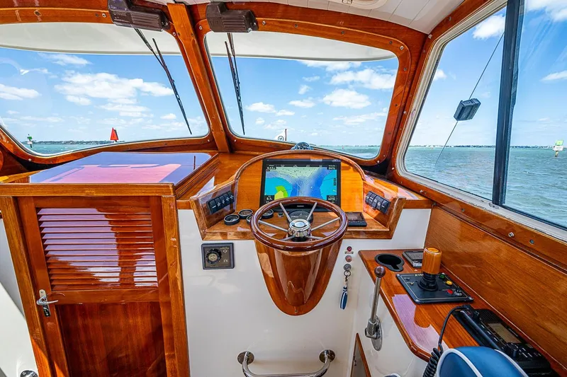 Slide: The Image of 2001 Hinckley Picnic Boat 36 Classic helm with wooden dashboard and navigation system. - 14