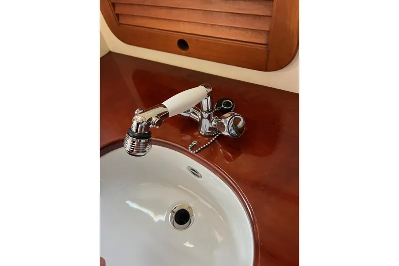 Slide: The Image of Sink and faucet on 2001 Hinckley Picnic Boat 36 Classic, featuring wooden countertop. - 18