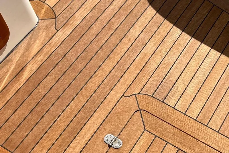 Slide: The Image of Teak deck of 2001 Hinckley Picnic Boat 36 Classic, showcasing elegant wood finish. - 19