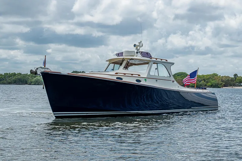 Slide: The Image of 2001 Hinckley Picnic Boat 36 Classic cruising on a calm lake under cloudy skies. - 2