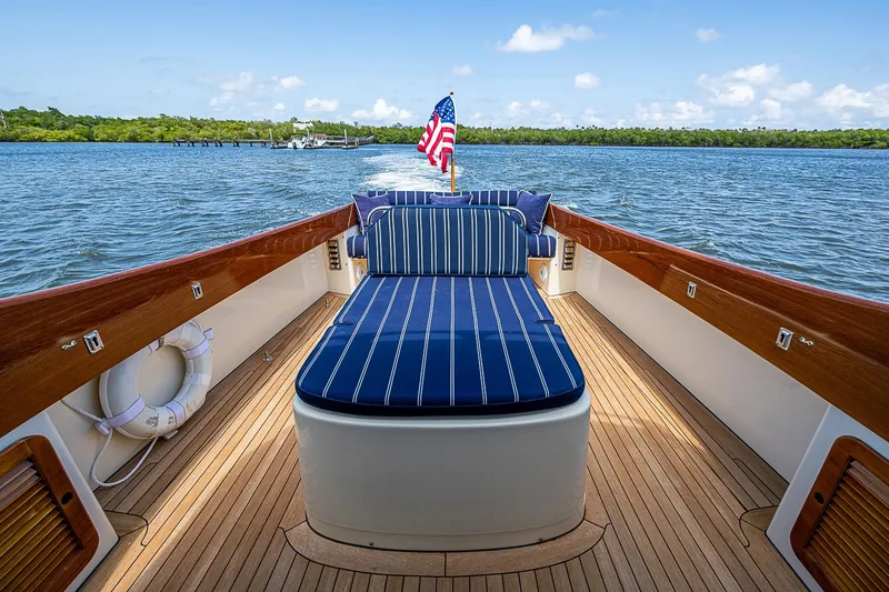 Slide: The Image of Hinckley Picnic Boat 36 Classic, 2001, with striped seating, cruising on a sunny day. - 9