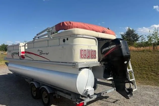 Slide: The Image of 2004 Bennington 2275LX pontoon boat with Mercury outboard motor on trailer. - 10