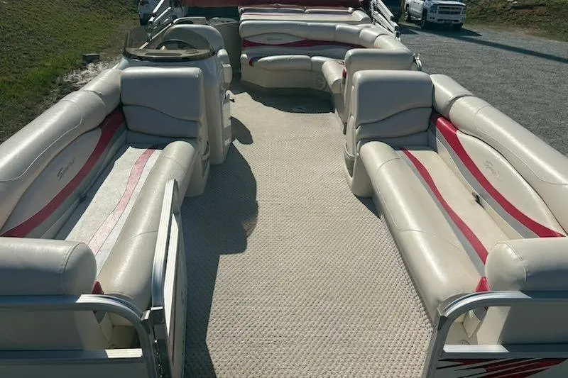Slide: The Image of 2004 Bennington 2275LX pontoon boat with spacious seating and beige upholstery. - 5