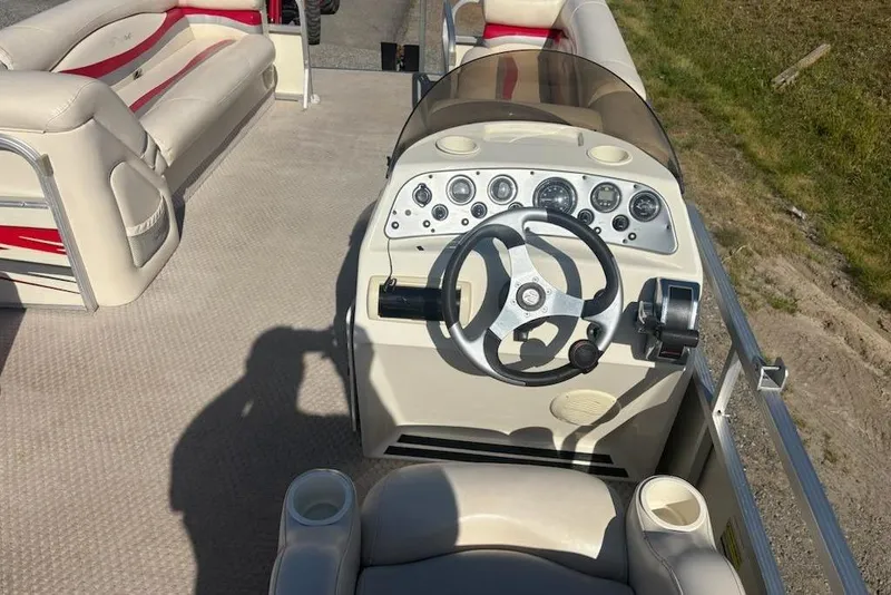 Slide: The Image of 2004 Bennington 2275LX boat interior with steering wheel and seating. - 6