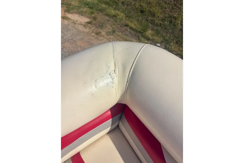 Slide: The Image of Close-up of 2004 Bennington 2275LX boat seat with minor wear and red accents. - 7