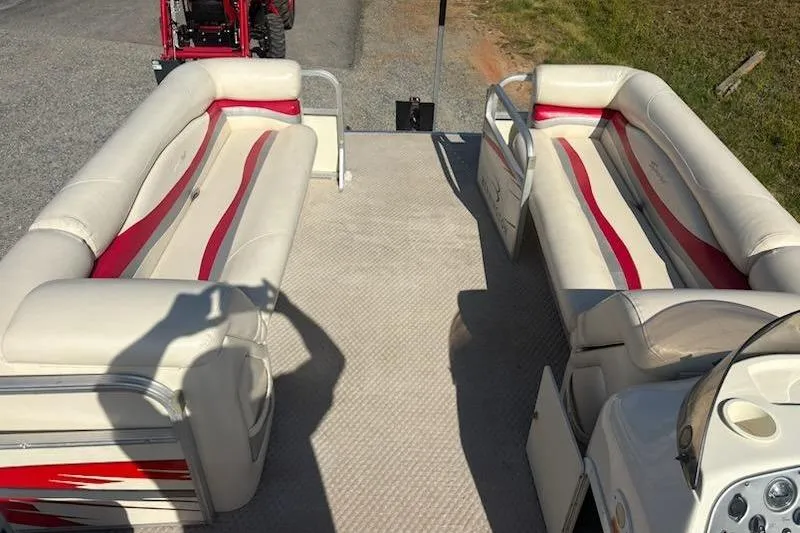 Slide: The Image of 2004 Bennington 2275LX pontoon boat interior with beige and red seating. - 8