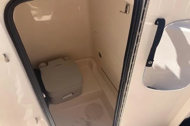 Slide: The Image of 2023 Grady-White Fisherman 236 boat interior with portable toilet. - 11