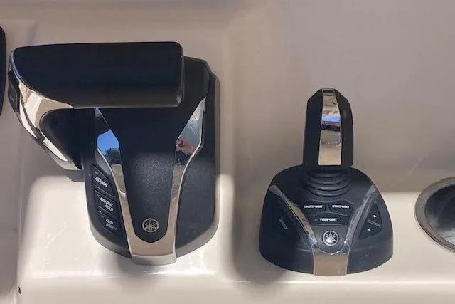 Slide: The Image of Throttle and joystick controls on a 2023 Grady-White Fisherman 236 boat. - 12