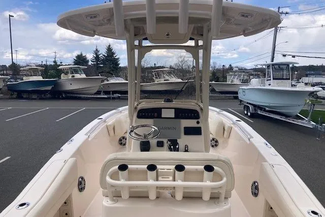 Slide: The Image of 2023 Grady-White Fisherman 236 boat with center console and rod holders, parked outdoors. - 3