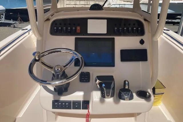 Slide: The Image of 2023 Grady-White Fisherman 236 boat dashboard with steering wheel and control panel. - 9