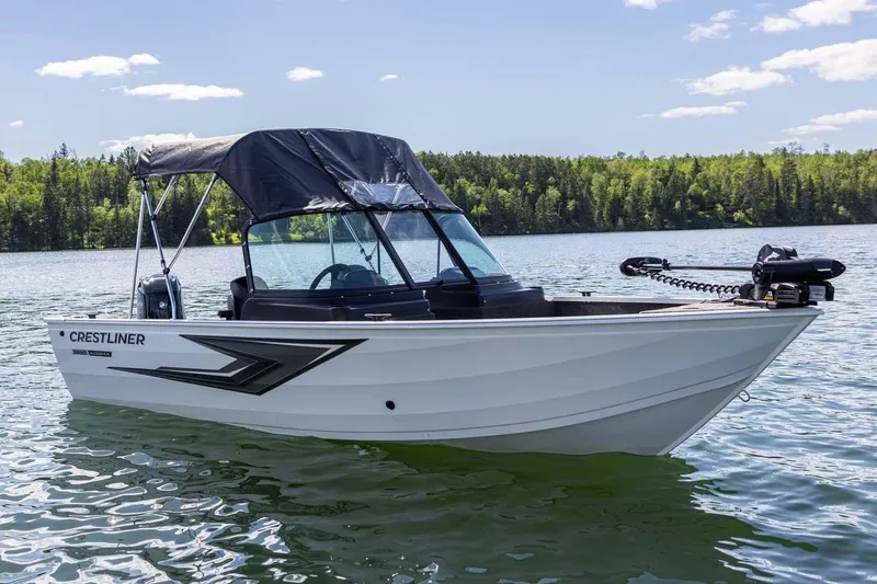 Slide: The Image of Manufacturer Provided Image: 2026 Crestliner 1650 Kodiak WT boat on a serene lake with forested background. - 2