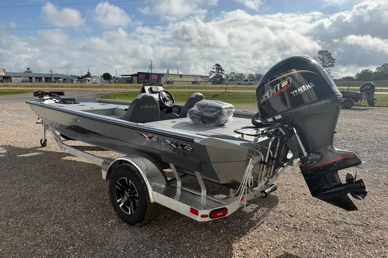 Slide: The Image of 2026 Vexus Defender 189 boat with Yamaha engine on a trailer, parked outdoors. - 3