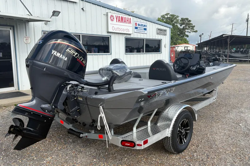 Slide: The Image of 2026 Vexus Defender 189 boat with Yamaha outboard motor, parked outside dealership. - 6