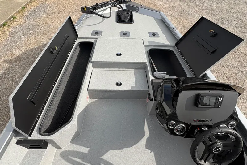 Slide: The Image of 2026 Vexus Defender 189 boat interior with open storage compartments and steering console. - 8