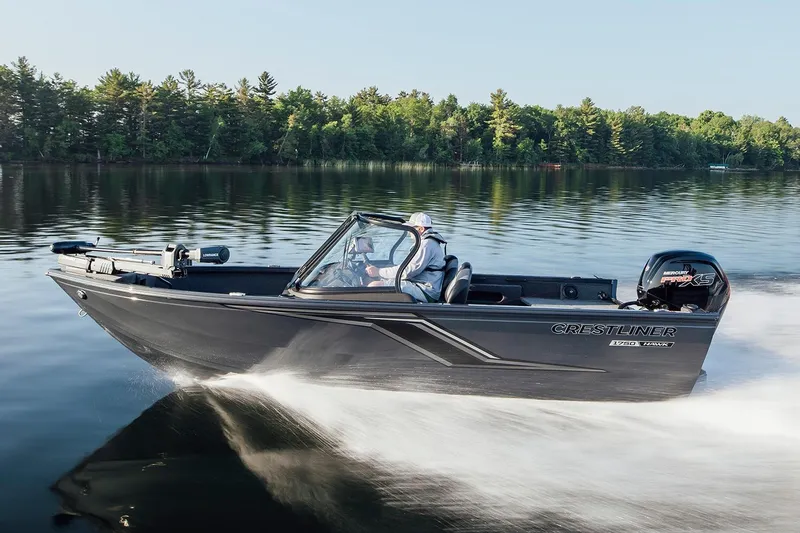 The Image of Manufacturer Provided Image: 2026 Crestliner 1750 Hawk WT boat cruising on a serene lake with forest backdrop. - 0