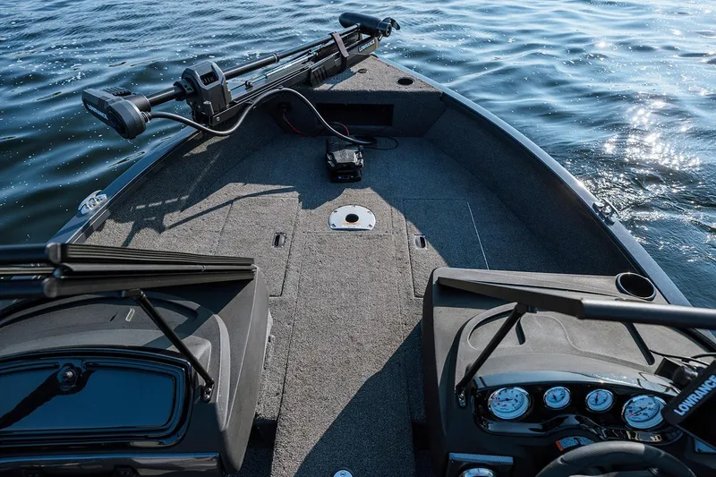 Slide: The Image of Manufacturer Provided Image: 2026 Crestliner 1750 Hawk WT boat interior with fishing equipment on a calm lake. - 2