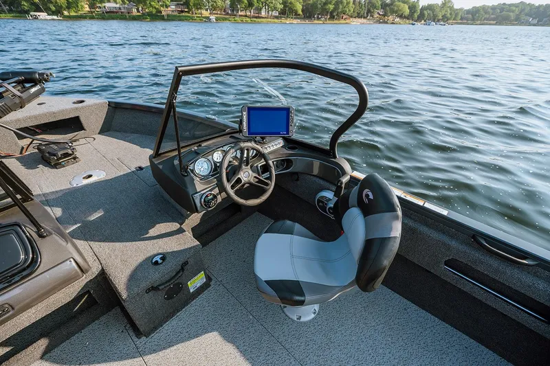 Slide: The Image of Manufacturer Provided Image: 2026 Crestliner 1750 Hawk WT boat interior with steering wheel and navigation system on a lake. - 4