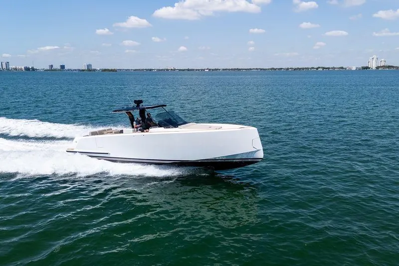 Slide: The Image of 2022 Pardo Yachts 38 with spacious deck, luxurious seating, and triple Mercury outboard engines. - 15
