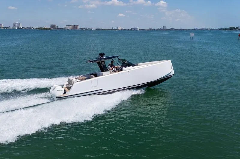Slide: The Image of 2022 Pardo Yachts 38 with elegant seating and table on deck, cruising on calm waters. - 20