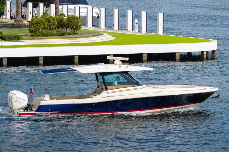 Slide: The Image of 2022 Chris-Craft Calypso 35 cruising on water near a dock. - 13