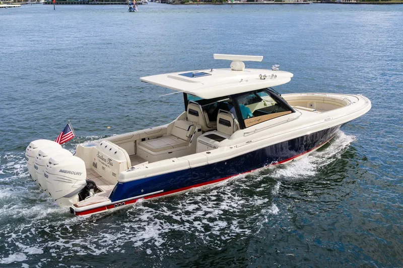 Slide: The Image of 2022 Chris-Craft Calypso 35 boat cruising on water with triple Mercury engines. - 15