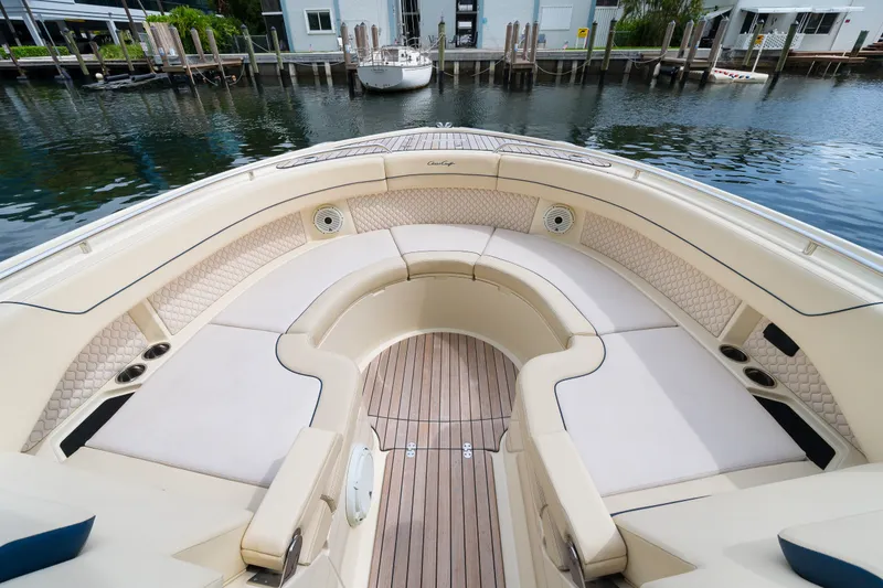 Slide: The Image of Luxurious seating area on 2022 Chris-Craft Calypso 35 boat, docked by waterfront homes. - 19