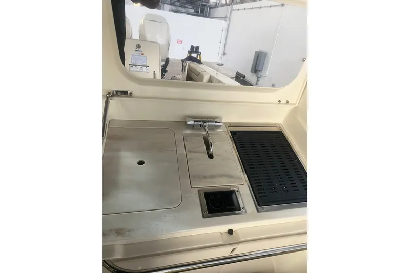 Slide: The Image of 2022 Chris-Craft Calypso 35 boat interior with sink and grill station. - 10