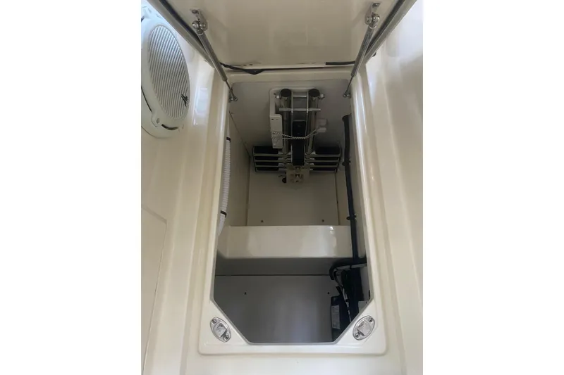 Slide: The Image of 2022 Chris-Craft Calypso 35 storage compartment with mechanical components visible. - 12