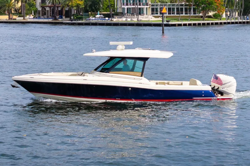 The Image of 2022 Chris-Craft Calypso 35 boat cruising on a calm waterway. - 1
