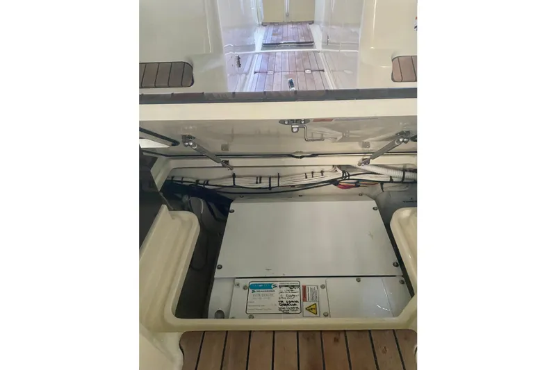 Slide: The Image of 2022 Chris-Craft Calypso 35 engine compartment with visible wiring and components. - 16