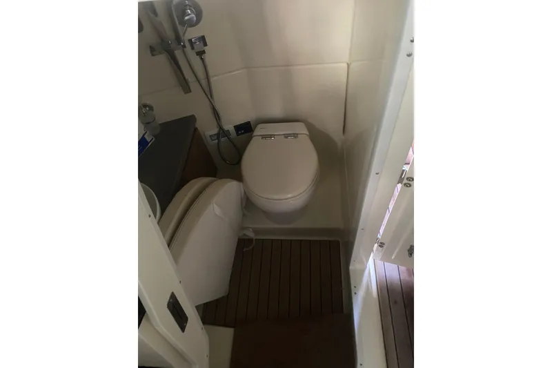 Slide: The Image of Bathroom interior of 2022 Chris-Craft Calypso 35 boat, featuring modern toilet and fixtures. - 18