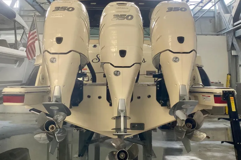 Slide: The Image of Triple 350 horsepower engines on a 2022 Chris-Craft Calypso 35 boat in a garage. - 2