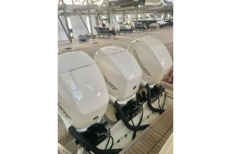 Slide: The Image of Triple Mercury outboard engines on a 2022 Chris-Craft Calypso 35 in a boatyard. - 4