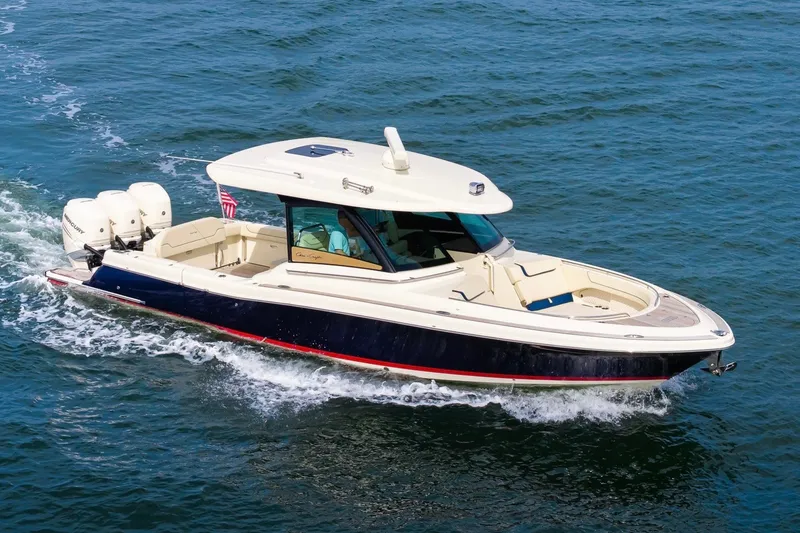 Slide: The Image of 2022 Chris-Craft Calypso 35 cruising on open water, showcasing elegant design and powerful engines. - 4