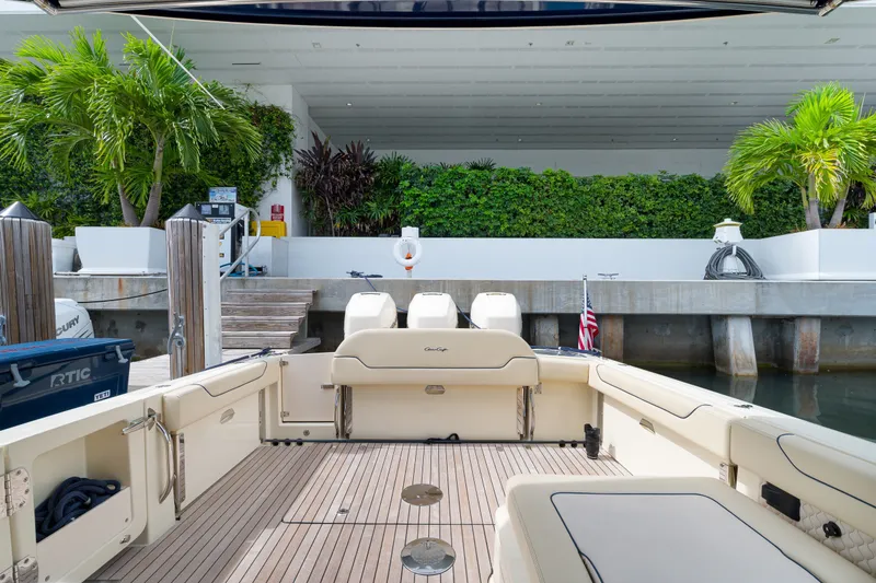 Slide: The Image of 2022 Chris-Craft Calypso 35 boat docked, featuring spacious deck and lush greenery backdrop. - 25