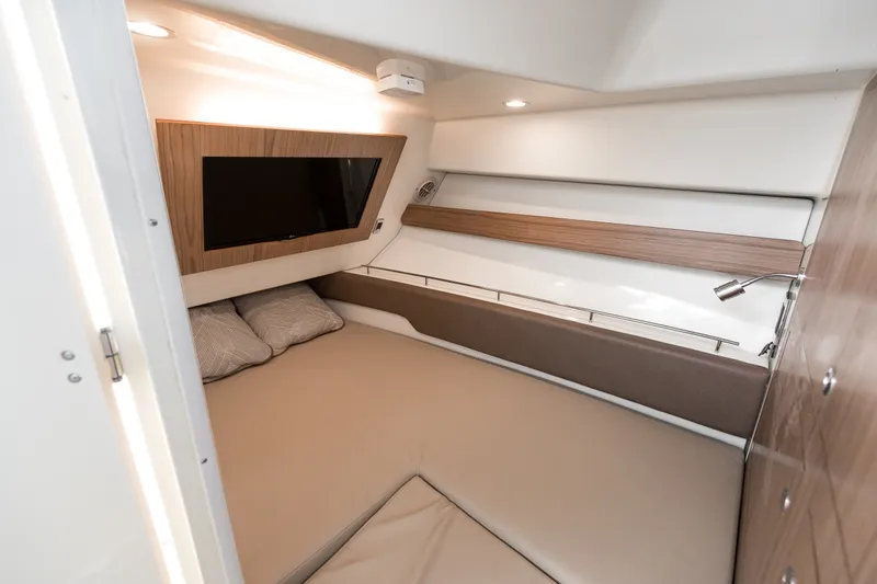 Slide: The Image of 2022 Chris-Craft Calypso 35 cabin interior with bed, TV, and modern lighting. - 18